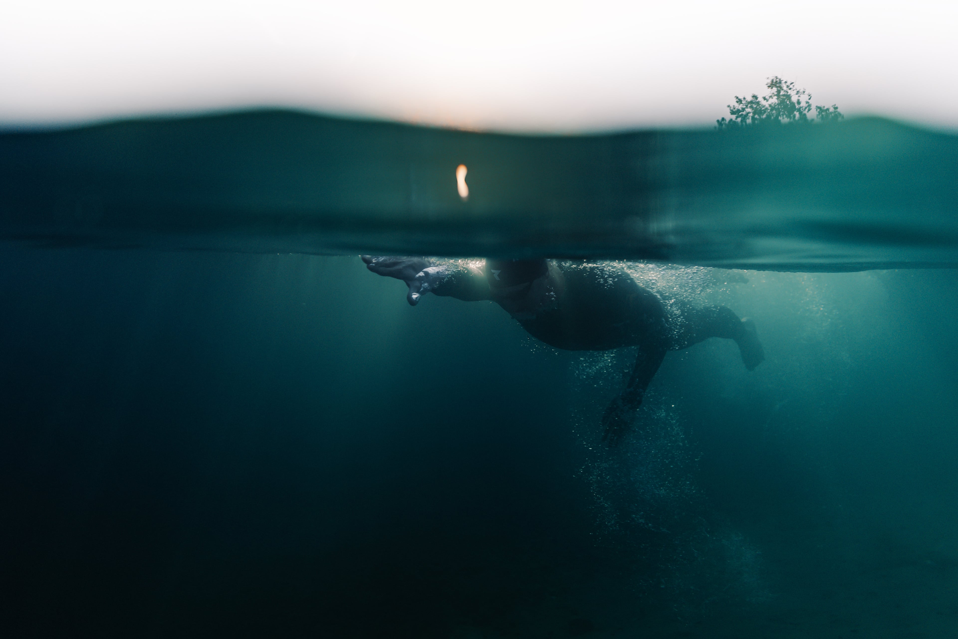 Underwater swimming at sunset - Kevin training in open water